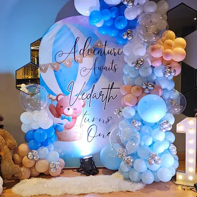 The complete setup for Vedarth's 'Adventure Awaits' first birthday. I combined a custom printed backdrop with multi-colored balloon arches and floor arrangements to create a full, immersive photo zone.