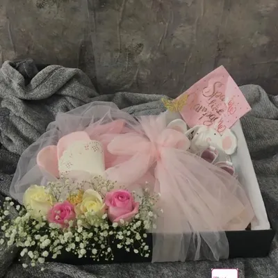 It was a true pleasure to create this luxury newborn hamper to welcome a precious baby girl. This bespoke gift box features fresh roses and baby's breath, a soft elephant toy, and practical baby essentials, all wrapped in delicate pink tulle for an elegant presentation.