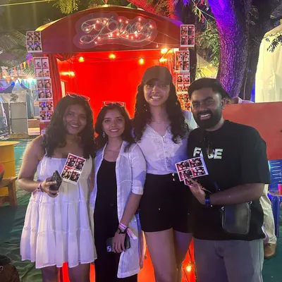 Friends, fun, and photo strips. This group is all smiles after their session in the booth at an evening festival. It's the perfect way to capture a fun night out with your favorite people.