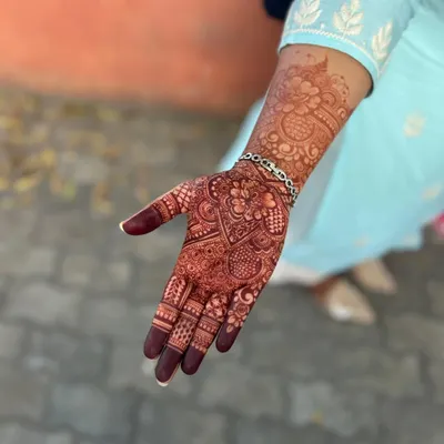The final stain of a full, intricate bridal design. This deep maroon color is the result of high-quality organic henna and proper aftercare.