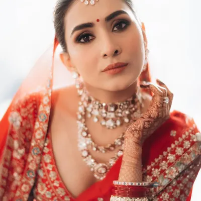 A stunning close-up of the bride, showcasing her flawless makeup and exquisite jewelry. I use soft, natural light to highlight her features and create a classic, elegant portrait.