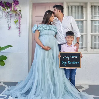 The perfect family announcement. Our flowy Elsa gown provides plenty of room for a soon-to-be big brother to join the photo.