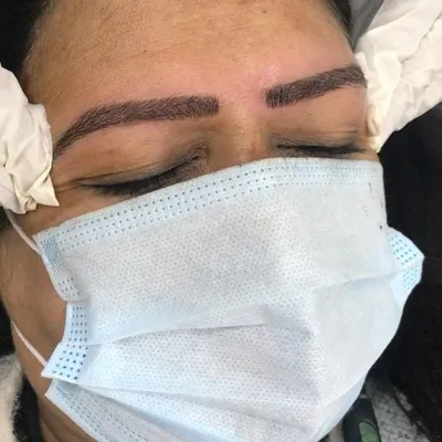 Here is the final result of our eyebrow microblading service. Notice the clean, natural-looking hair strokes that create a fuller, perfectly defined brow shape, eliminating any patchiness for a polished look.