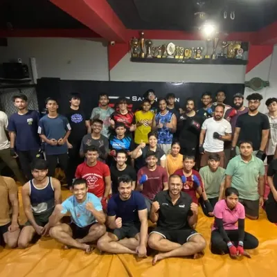 The spirit of our team is our greatest shield. A group photo capturing the energy and camaraderie of our students and coaches at the gym.