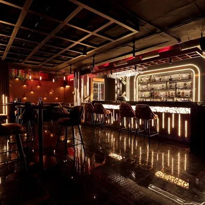 A view of the bar at Harmony Inn, where we installed a complete lighting automation system. The dynamic Hybec lighting, controlled by a Wiser system, creates a sophisticated and inviting atmosphere for patrons.