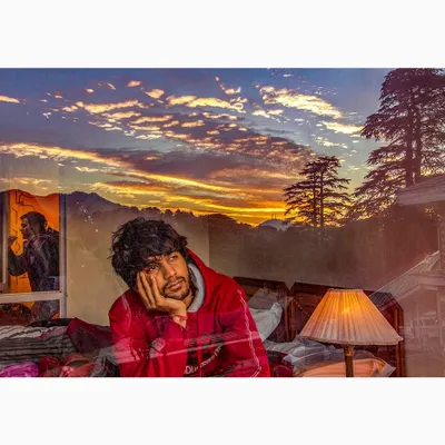 A multi-layered image from my 'Reflections of Life' series, combining an introspective portrait with a dramatic sunset over the mountains. This conceptual photograph explores themes of thought and solitude.
