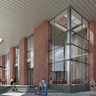The entrance to the KMYF Rehabilitation Center is designed to be both welcoming and inspiring. The rising volumes of brick and glass, combined with a perforated metal screen, create a dynamic interplay of solid and void. This design provides filtered light and a sense of arrival, setting a hopeful tone for a space dedicated to healing.