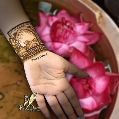 Simplicity speaks serenity. This minimal wristband design featuring a cow and lotus flowers is a perfect example of how a small, meaningful design can be incredibly beautiful.