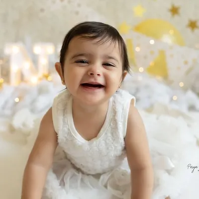 And look who's all smiles on her birthday! This is the moment just before the cake comes out, full of excitement and joy in our "Twinkle Star" setup. Her happy grin is just priceless.