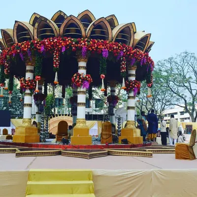 This breathtaking outdoor lotus-themed mandap is one of my signature rental pieces. The structure includes ornate pillars, a detailed floral canopy, and a multi-level stage for the ceremony.
