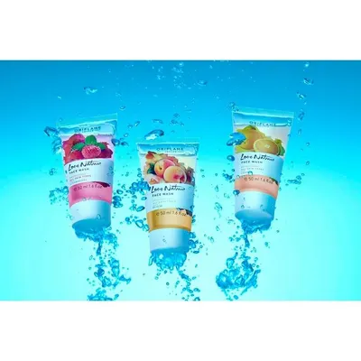 Three variants of the Love Nature face wash captured mid-splash against a vibrant blue background. This dynamic shot emphasizes the product's fruity ingredients and refreshing qualities for a youthful audience.