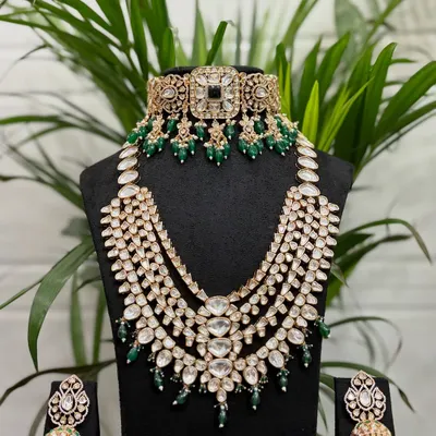 This is one of our most popular full bridal rental sets, featuring a Kundan choker, a magnificent multi-layered rani haar, and matching jhumkas with emerald green beadwork.