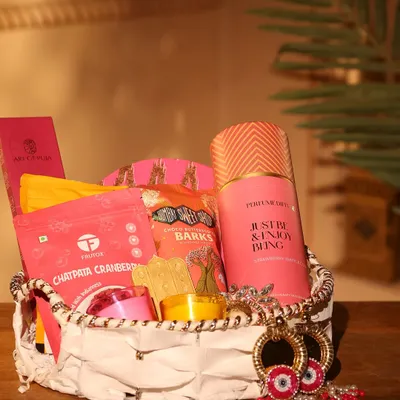 This vibrant pink-themed hamper is part of my Diwali collection, perfect for corporate or personal gifting. It includes gourmet snacks like Chatpata Cranberry, chocolate barks, a scented candle, and stylish evil-eye earrings.