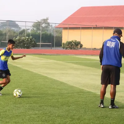 A NorthEast United FC coach provides personalized guidance to a young player at our Residential Academy. This demonstrates the hands-on, expert instruction our students receive as part of our ISL club partnership.