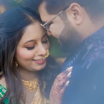 A soft and dreamy close-up, capturing a quiet, intimate moment between the couple on their wedding day.