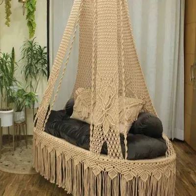 This is our classic sofa swing, shown here in a natural beige color. It has an elegant, elongated shape that provides ample seating space, perfect for a covered patio or a spacious living room.