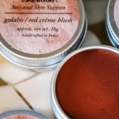 A close-up of my 'Gulabo' red crème blush, a multi-use tint for lips and cheeks. The rich color comes from natural red clay, providing a beautiful flush without any synthetic dyes.