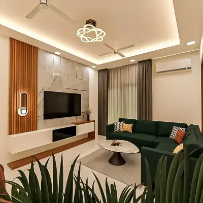 A contemporary living room featuring a floating white TV console set against a wall with marble and fluted wood panels. The integrated cove lighting in the ceiling and the modern wall sconce add layers of warmth to the space.