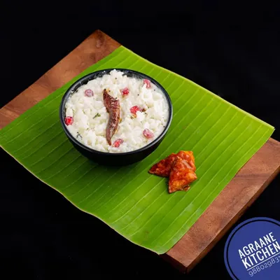The perfect end to any South Indian meal, my Curd Rice. It's tempered with spices and garnished with pomegranate seeds, served here traditionally on a banana leaf with a side of pickle.