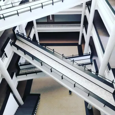 The bridge network inside an ongoing institutional project in Bengaluru. This system of zigzagging bridges creates dynamic visual communication and physical connectivity between different departments across a multi-story atrium.
