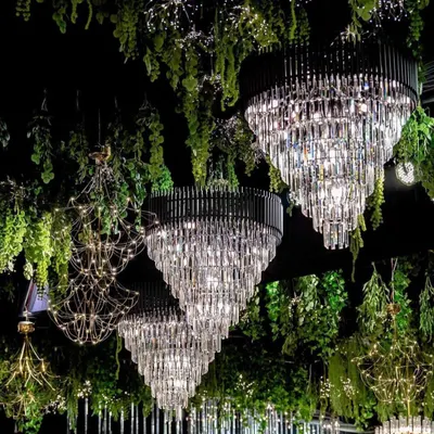 We create breathtaking ceiling installations that transform a venue. Here, magnificent crystal chandeliers are suspended among hanging greenery, creating a magical, forest like canopy for a truly enchanting gala dinner.