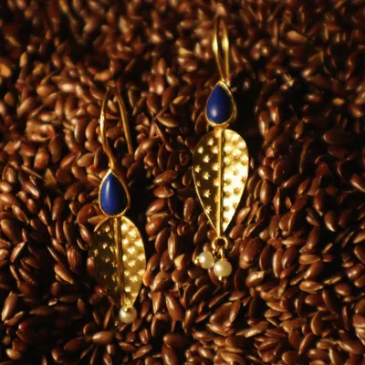 Lapis, gold, and pearls come together in these earrings, mirroring the fullness of a new season. They are crafted from sterling silver with 18k gold plating.