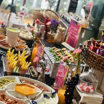 A beautiful summer afternoon table setting featuring a variety of our favorite snacks. This spread includes a dip platter, crispy fries, fresh juices, and other gourmet bites perfect for a relaxed get-together with friends and family.