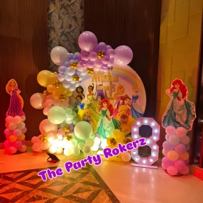 A magical Disney Princess-themed 8th birthday. The main backdrop features a rainbow and multiple princesses, framed by a pastel balloon arrangement and character cutouts.