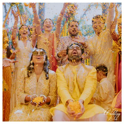 The quintessential "phoolon ki haldi" shot. I ensure these moments are not just chaotic fun but also beautifully captured, surrounded by friends and family.