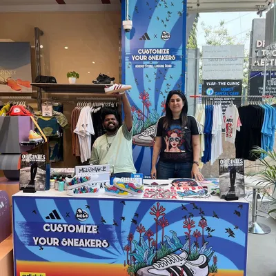 Our live customization booth, set up and ready for action at the Adidas store on Linking Road, Mumbai. We provide a fully branded and interactive art experience that draws crowds and adds a creative flair to any retail space or event.
