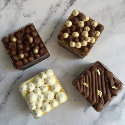 My dessert tubs are perfectly portioned treats made just for one. This assortment shows four different flavors, including a rich chocolate tub and a light lemon meringue tub.