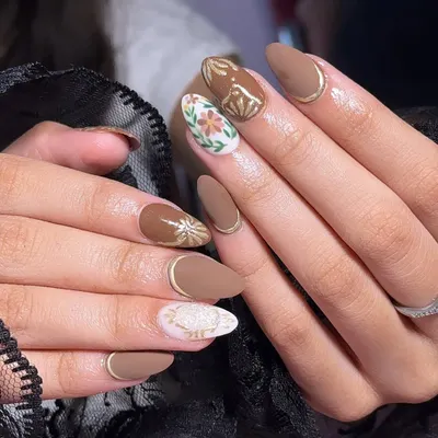 A beautiful matte and gloss combo. This set features a solid matte brown, gold chrome accents, and intricate hand-painted floral designs on a white base.