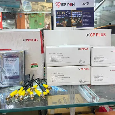 This is a standard 4-camera CP Plus Full HD setup. It includes four cameras, a 1TB Western Digital surveillance hard drive, connectors, and a power supply. Everything you need for a complete installation.