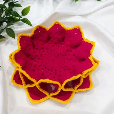 A stack of my handmade lotus coasters in a vibrant rani pink and yellow combination. The 3D petal design gives them a beautiful, blooming effect.