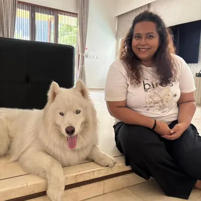 This is me with Romeo, a handsome husky who graduated from our behavior modification program. We worked through some tough, deep-rooted triggers to help him find his calm.