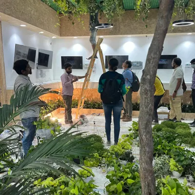 A behind-the-scenes look at our team setting up for a major event. We meticulously place each plant according to the design plan to create a full, immersive experience.