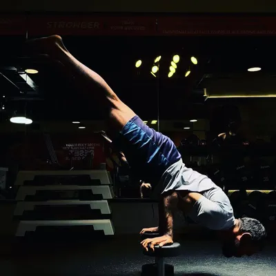 A handstand performed on a dumbbell. This variation takes balance to another level, requiring intense focus, wrist strength, and core engagement. It proves that you can build incredible strength with minimal equipment.