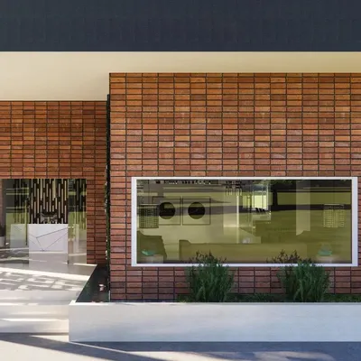 For this marketing office, I designed a facade that is both timeless and modern. The terracotta cladding will develop a beautiful patina over time, while the large window frames the interior like a picture. The screened foyer with jaalis creates beautiful moving shadows, symbolizing the ever-evolving nature of design.