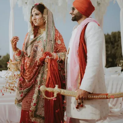 A Sikh couple stands together during their Anand Karaj ceremony. We specialize in capturing the reverence of these moments.