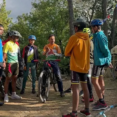 A key part of our workshops is the pre-ride briefing. Here, our coach Rakesh Rana explains the day's plan and shares essential techniques with a group of young riders before they hit the trails in Mukteshwar.