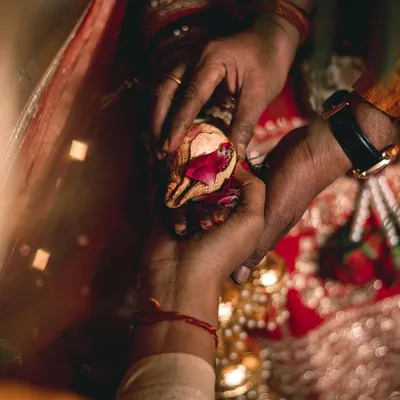 A different perspective of the Kanyadan ceremony. This angle shows the parents' hands giving their daughter's hand away, a poignant and deeply meaningful part of the Indian wedding tradition.