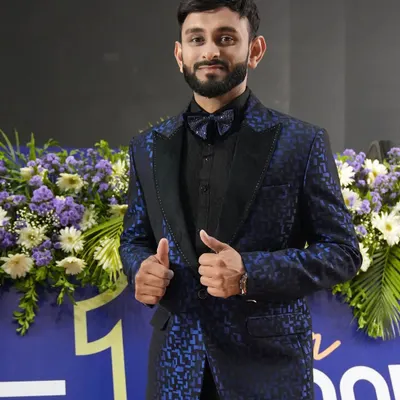 Sporting a custom-designed blue patterned tuxedo. This look is perfect for a formal awards ceremony or a stylish corporate gala, ensuring I complement the event's aesthetic.