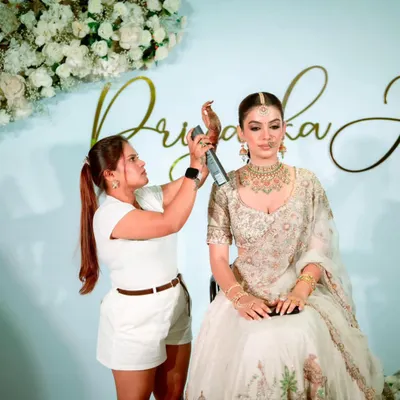 In my element, giving the final touches to a bride's hairstyle. I make sure every detail is perfect before she walks down the aisle.