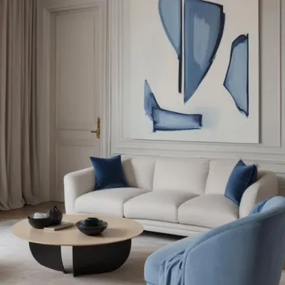 This living room pairs modern abstract art with soothing blue tones reminiscent of sky and sea. With natural textures and a soft palette, the space feels calm, curated, and deeply connected to coastal inspiration.
