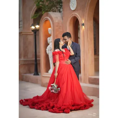 A fairytale moment captured against a backdrop of timeless architecture. This shot embodies the grand romance I love to create, with a stunning red gown that makes a bold, passionate statement.