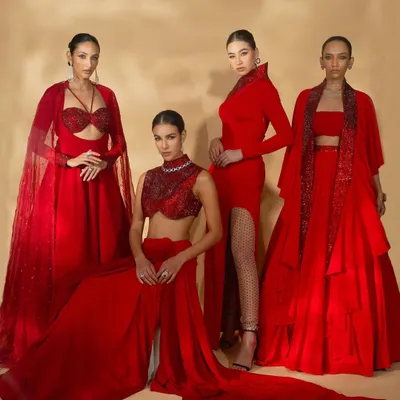 A group shot for Nikhil Thampi's 'Scarlet Edit', showcasing four models in coordinated red ensembles to highlight the collection's theme.