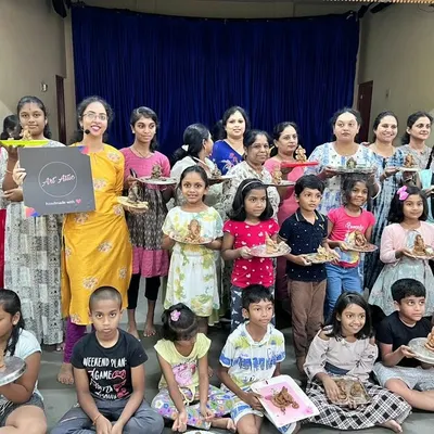 A wonderful group of adults and children proudly holding up the eco-friendly clay Ganesha idols they sculpted themselves. This workshop is a beautiful blend of tradition, creativity, and sustainability.
