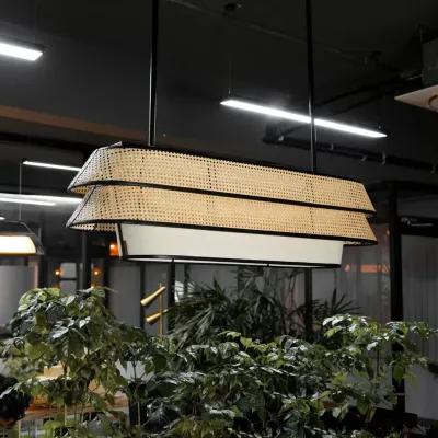 This two-tiered rattan chandelier makes a sophisticated statement, blending natural woven textures with a modern, linear form. It's an ideal lighting fixture for conference rooms, dining areas, or hotel lobbies, providing both ambient and direct light.