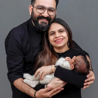 A beautiful family portrait with their newborn baby. The love and happiness in this photo are what it's all about.