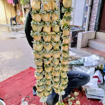 Here is another one of our popular varmala designs, being handcrafted by a member of our team. This garland is made with beautiful yellow roses and accented with delicate baby's breath for a fresh and elegant look.